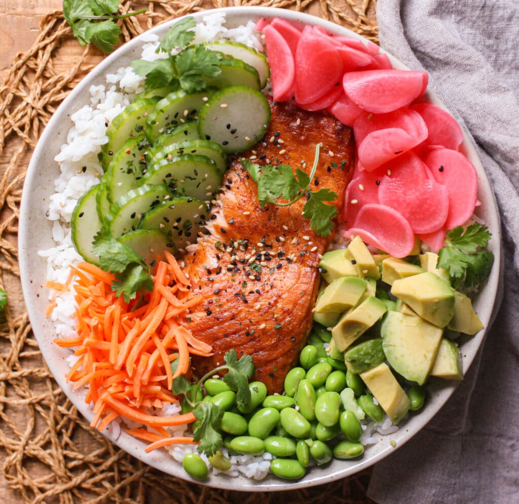 Salmon, avocado, pickled radishes, slice cucumber and edamame served over rice