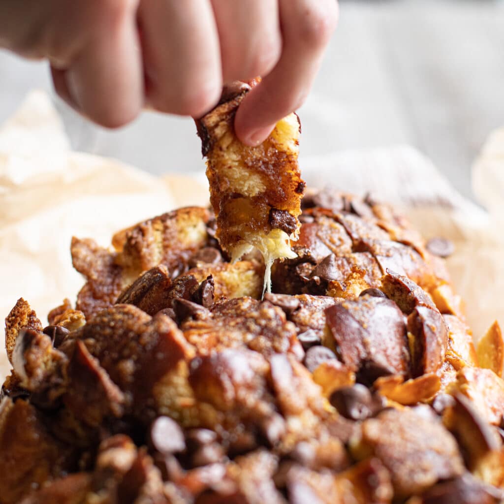 Fingers holding a piece of Chocolate Cinnamon Pull Apart Bread