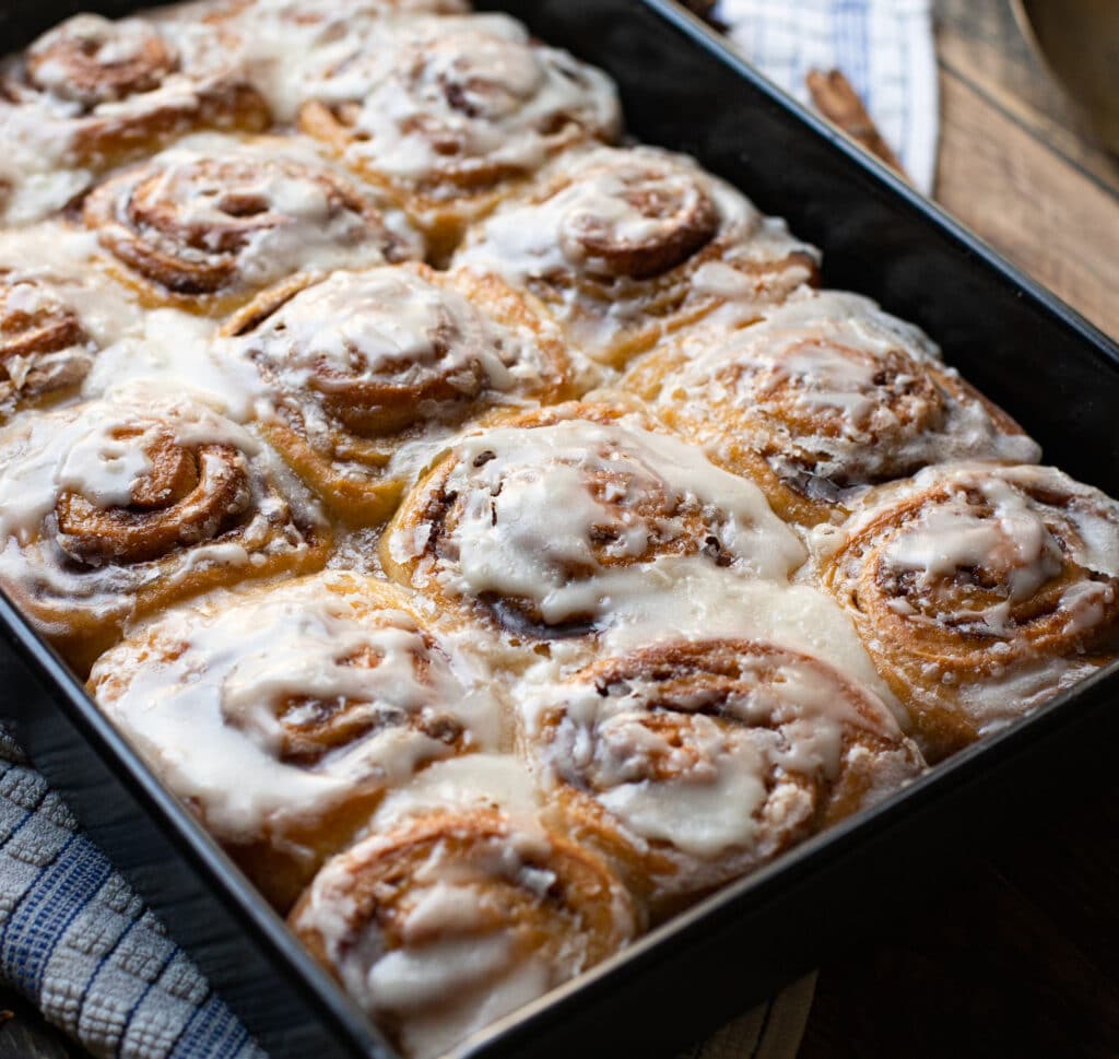 Classic Cinnamon Rolls with Vanilla Frosting in a baking dish