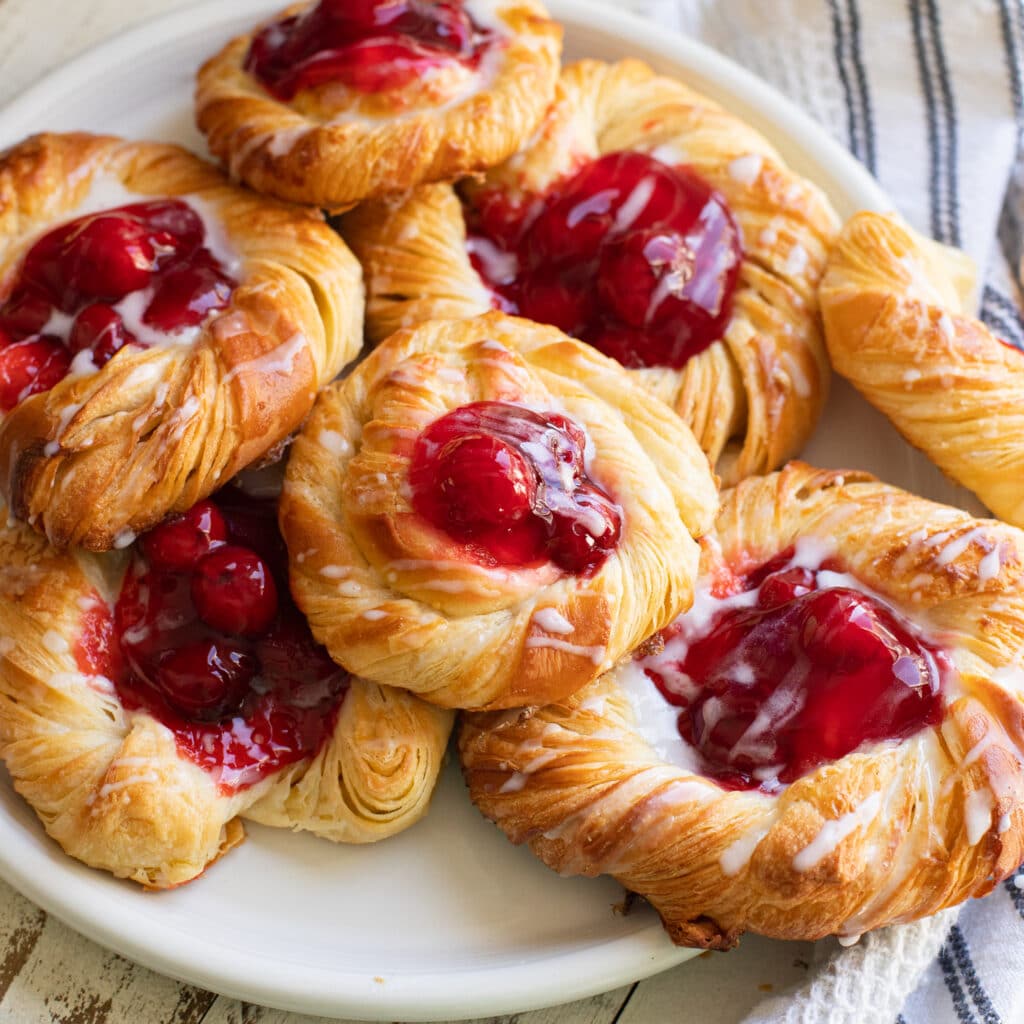 Sideways view of a plate of cherry danishes.