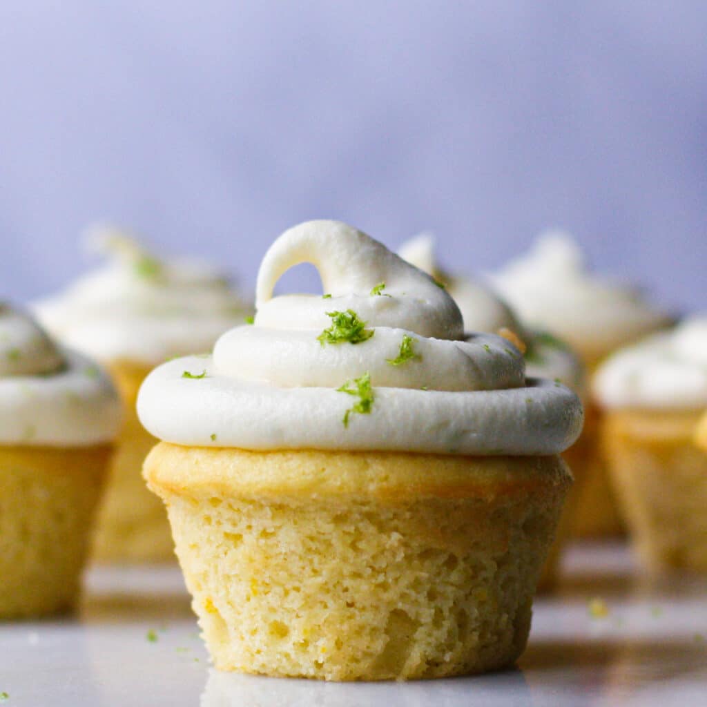 Yellow cake with white frosting sprinkled with green lime zest