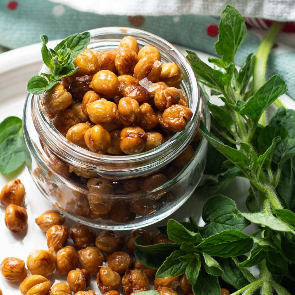 easy roasted chickpeas garnished with fresh oregano leaves