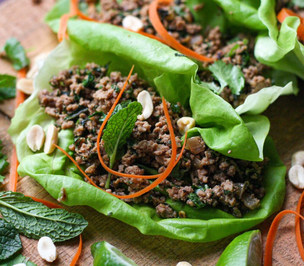 one lettuce wrap filled with ground turkey, peanuts, fresh mint and peanuts