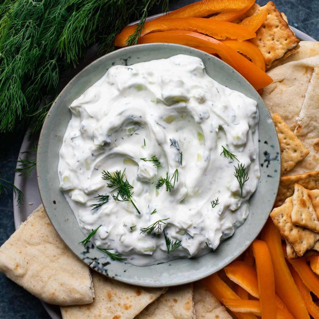 gluten free tzatziki sauce served with pita, crackers and fresh dill