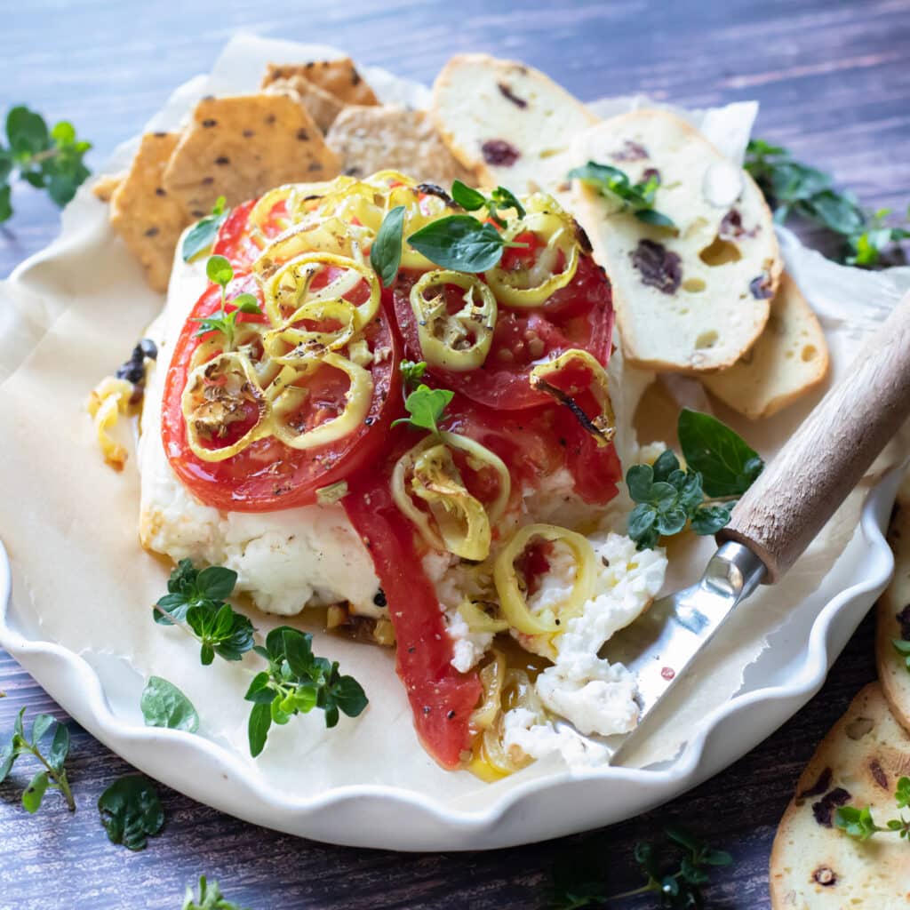 Baked feta cheese with tomatoes, fresh oregano and peppers