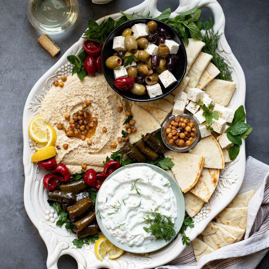 Greek Mezze Platter on a white serving tray against a gray background