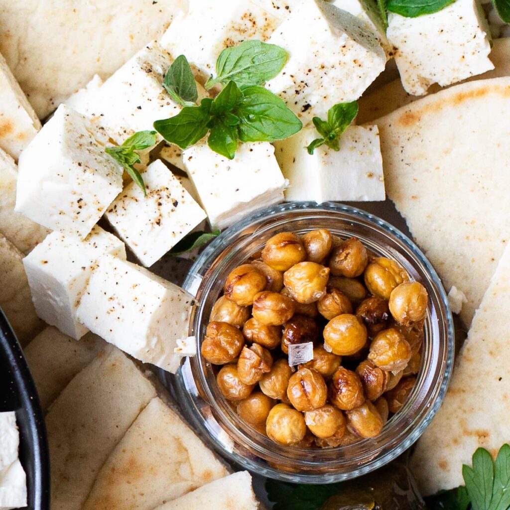 Crispy chickpeas in a glass jar with cubes of feta cheese