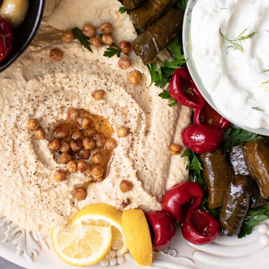 Hummus and crispy chickpeas, roasted red peppers and stuffed grape leaves