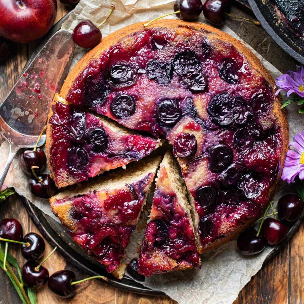 Cherry Plum Upside Down Cake with three slices cut out