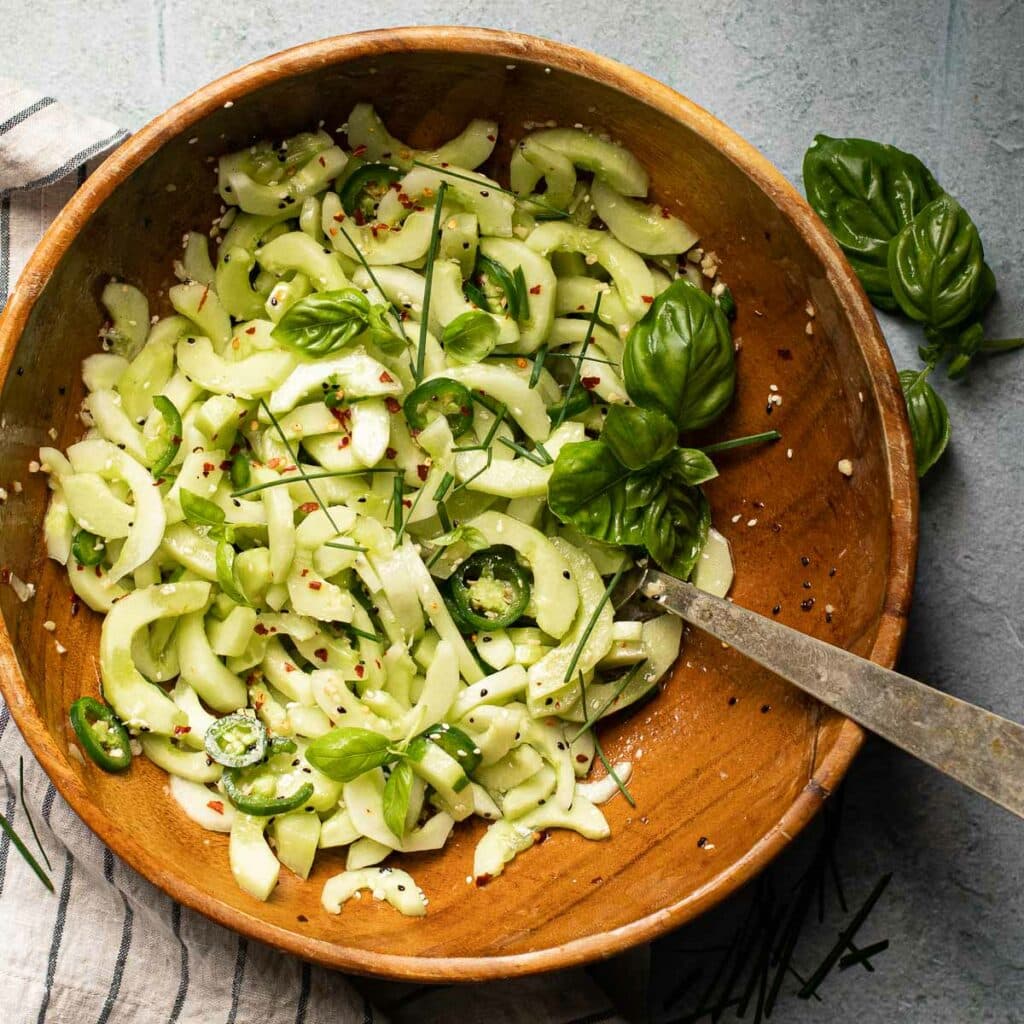 Asian Cucumber Salad with  jalapeño peppers in a wooden bowl