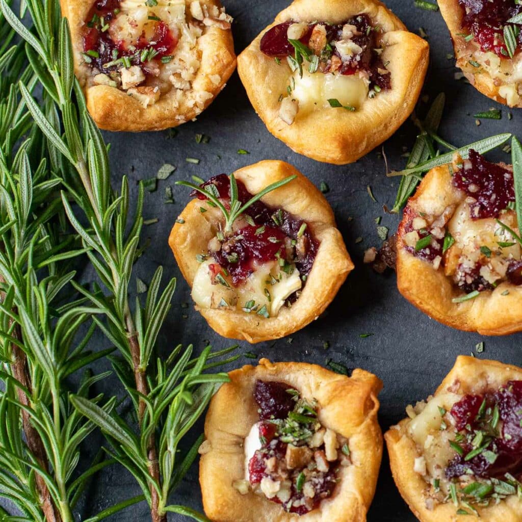 mini cranberry brie tarts with rosemary and chopped pecans