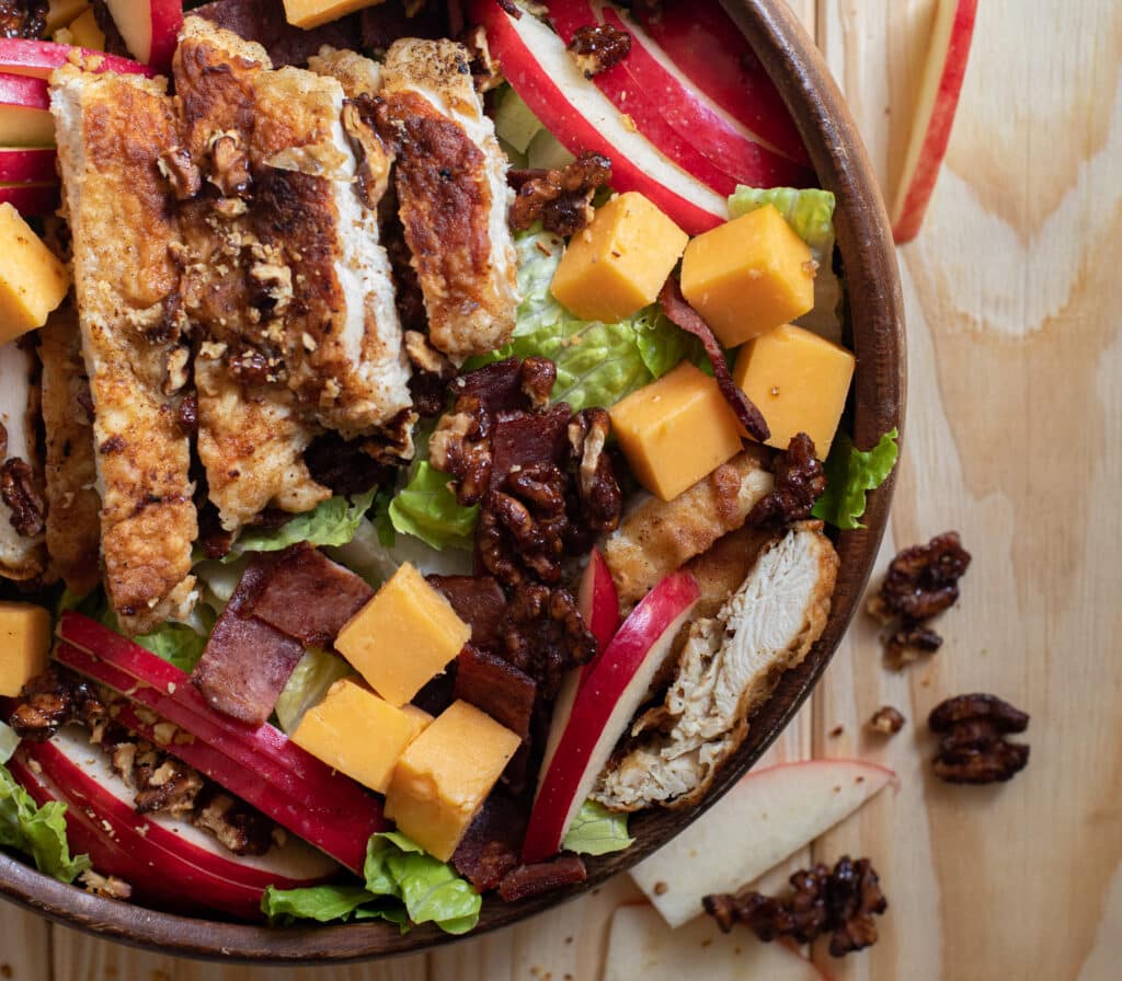 ultimate fall salad with cheddar cheese, pecans, bacon, chicken and apples