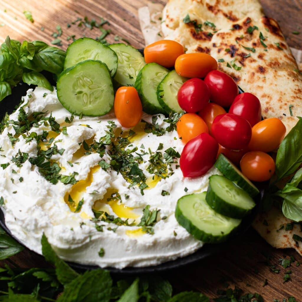 Labneh with fresh parsley, fresh mint, cucumbers and tomatoes