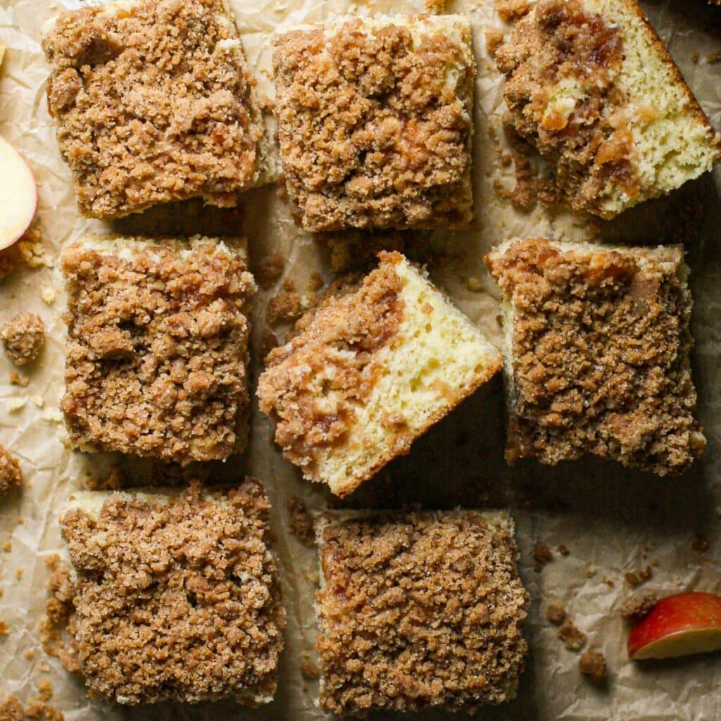 Apple Cinnamon Sour Cream Coffee Cake cut into squares on a piece of parchment paper