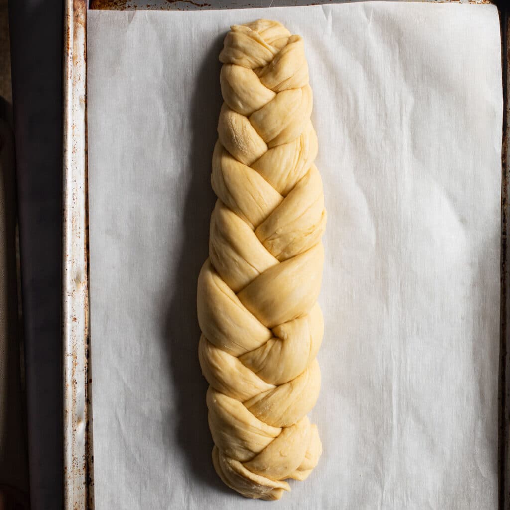 braided challah dough before it's baked