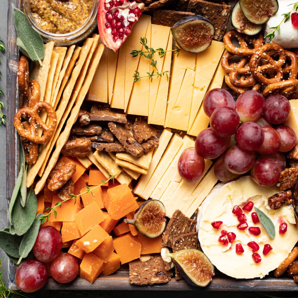 Fall cheese platter with red grapes and mini pretzels