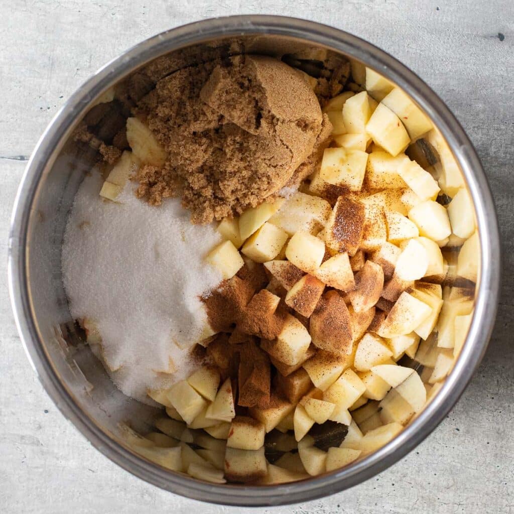 Top down view of the ingredients to make apple butter in the bowl of an Instant Pot