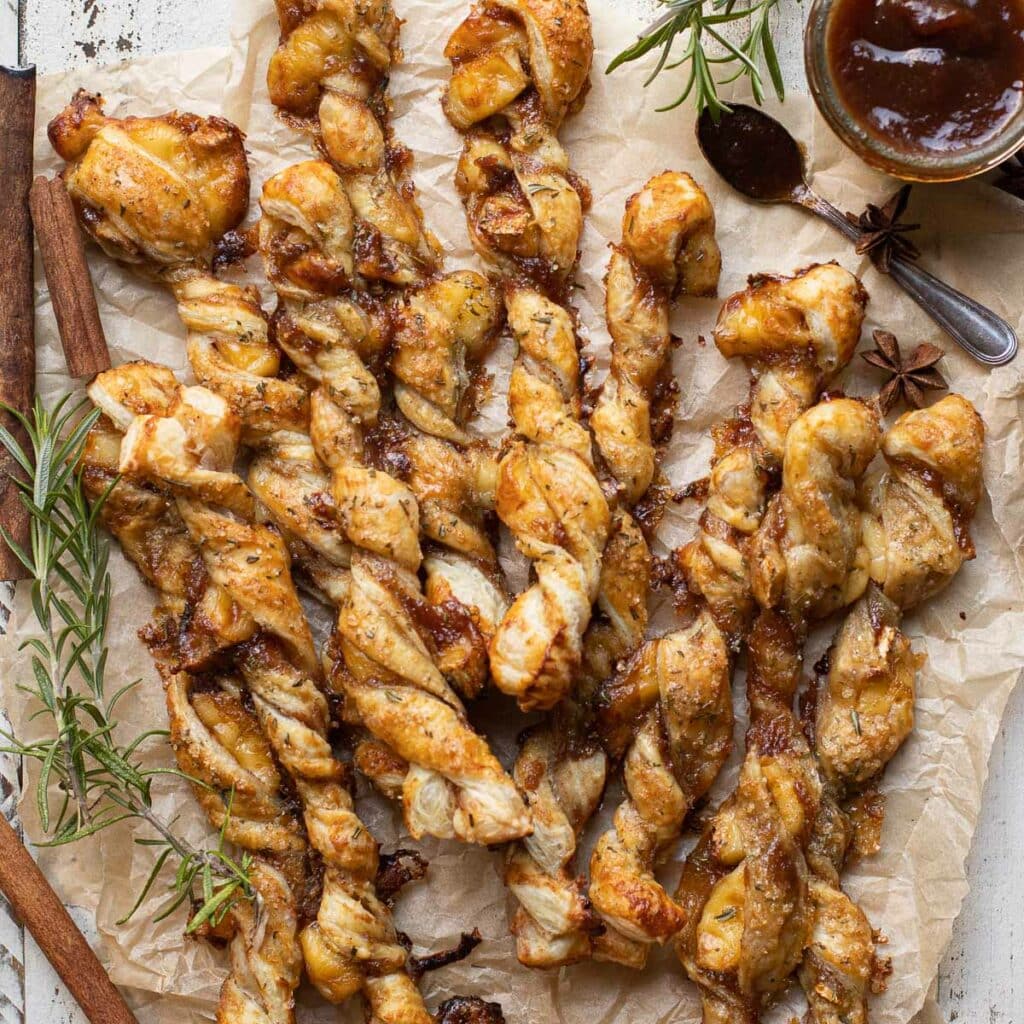 Apple Butter Baked Brie Puff Pastry Twists on parchment paper