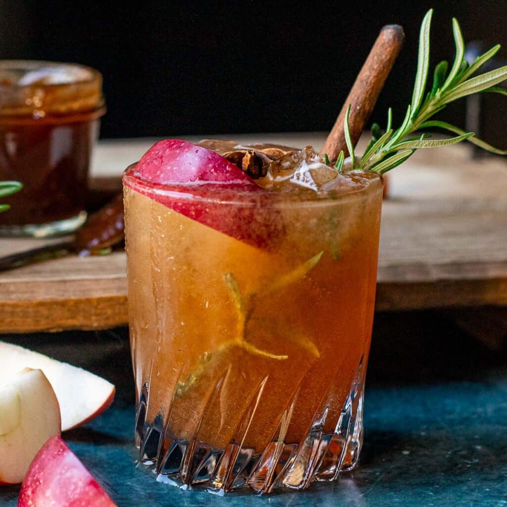 Apple Butter Vodka Cocktail garnished with rosemary and cinnamon stick