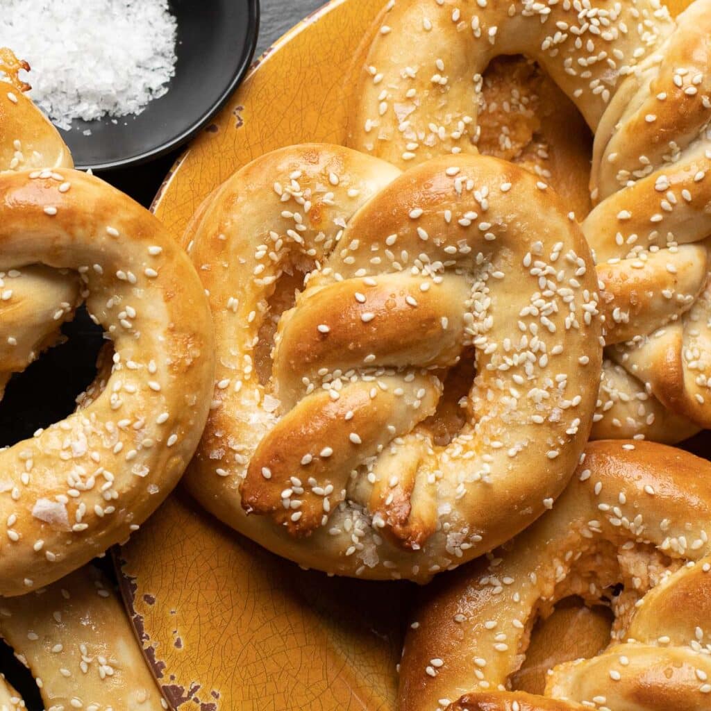 soft pretzel filled with cheese and topped with sesame seeds