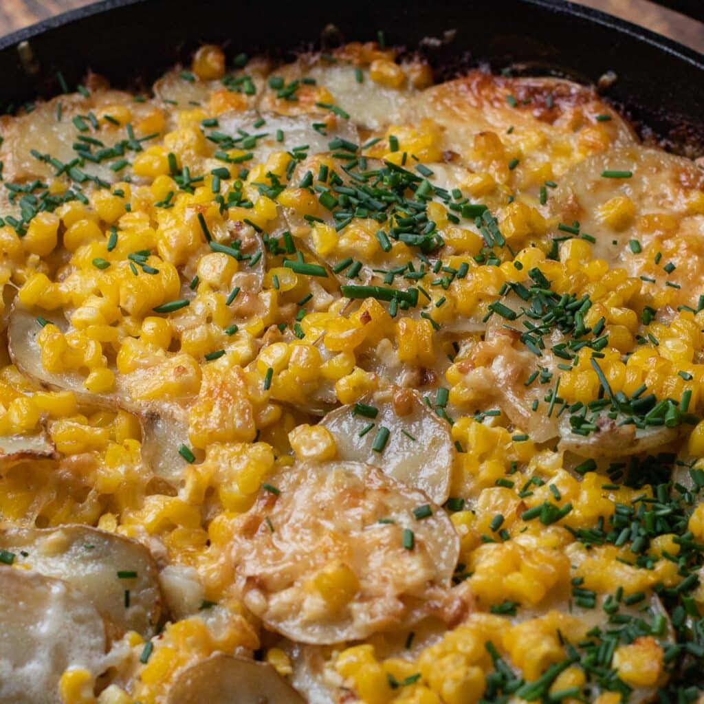 Potatoes Au Gratin with Gruyere Cheese and Corn, garnished with chopped chives
