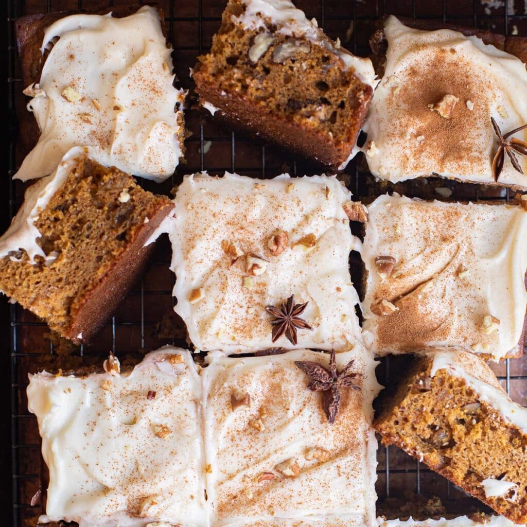 pumpkin spice cake, cut into squares, topped with cream cheese frosting and star anise