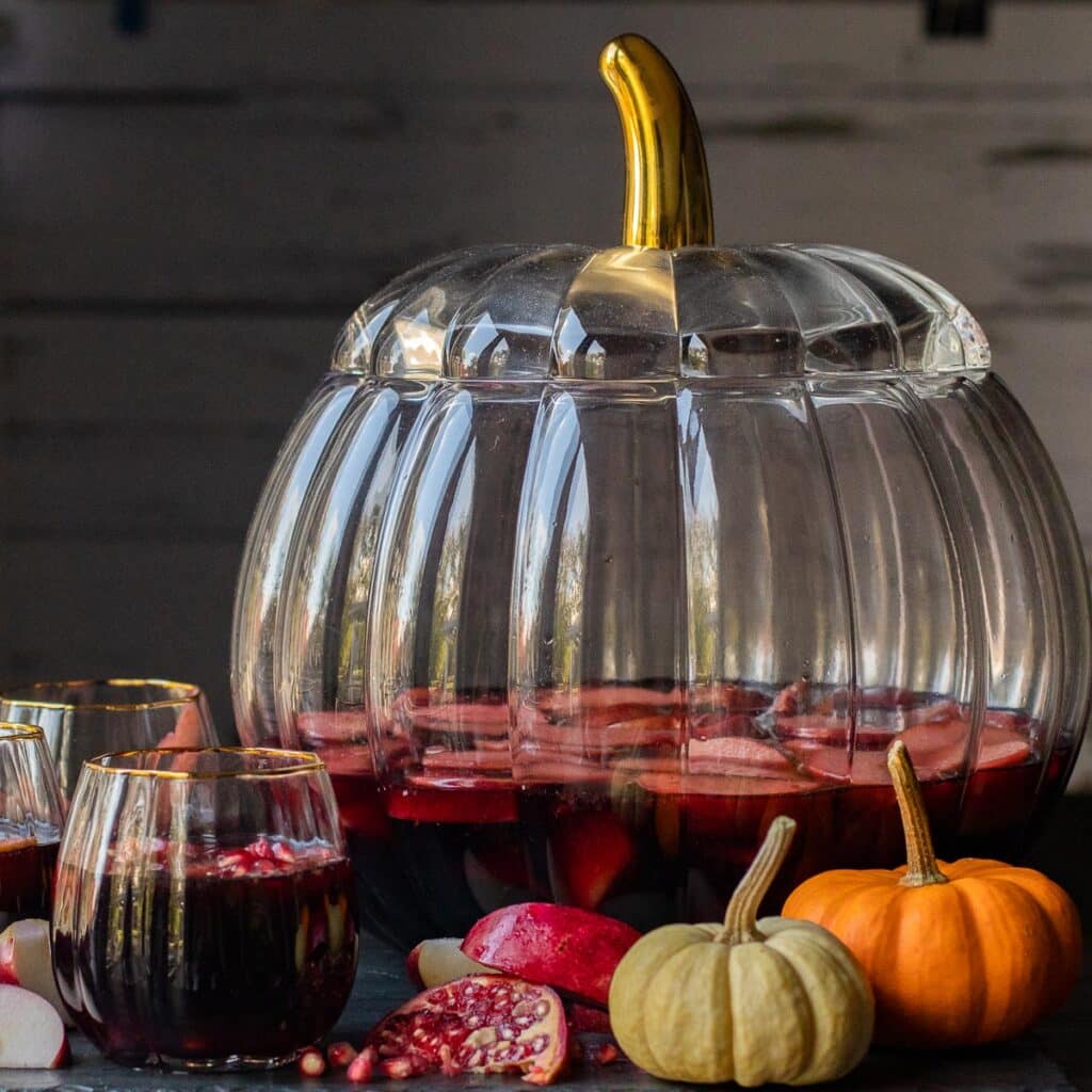 Thanksgiving sangria in a glass pumpkin-shaped punch bowl