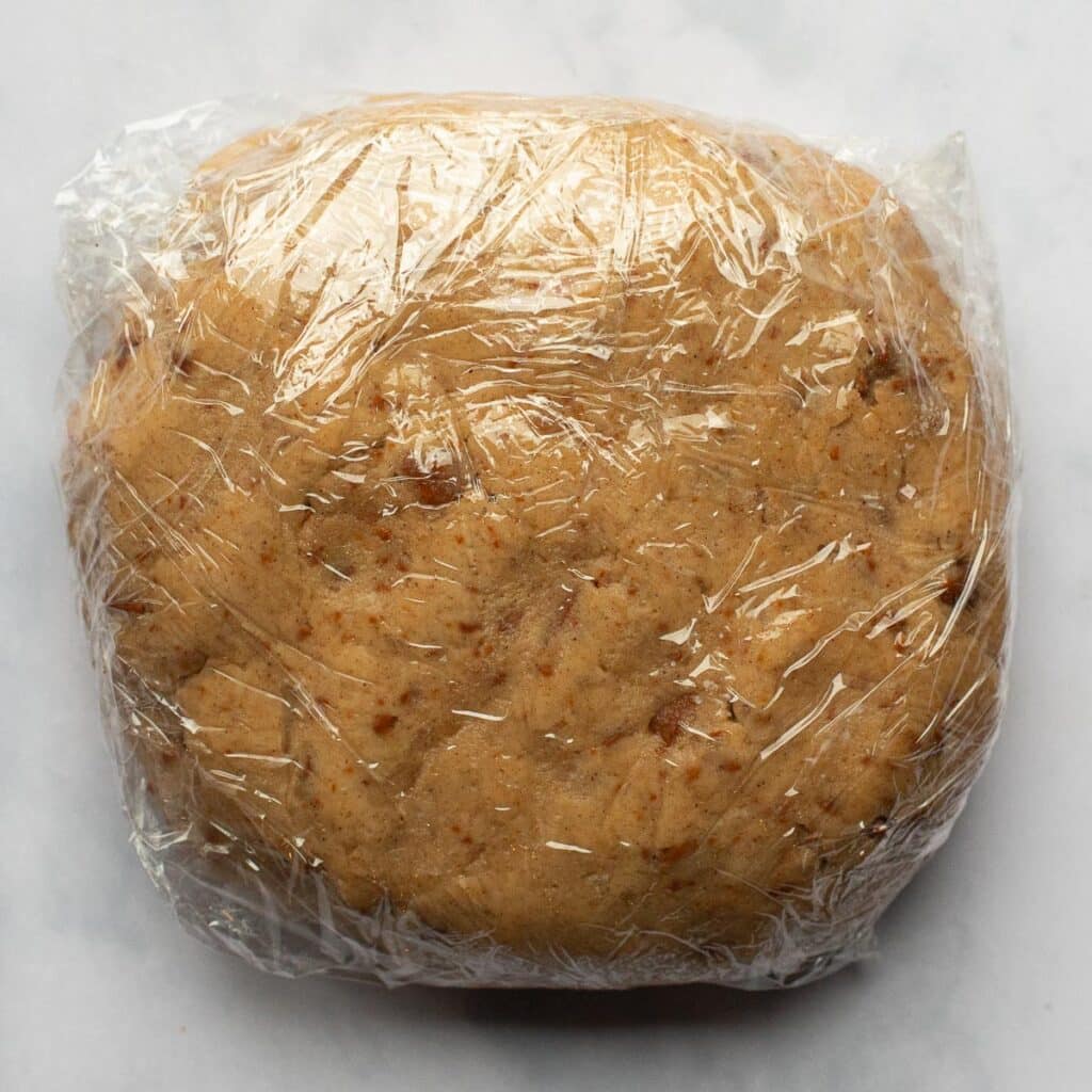 A disc of cookie dough, wrapped in plastic
