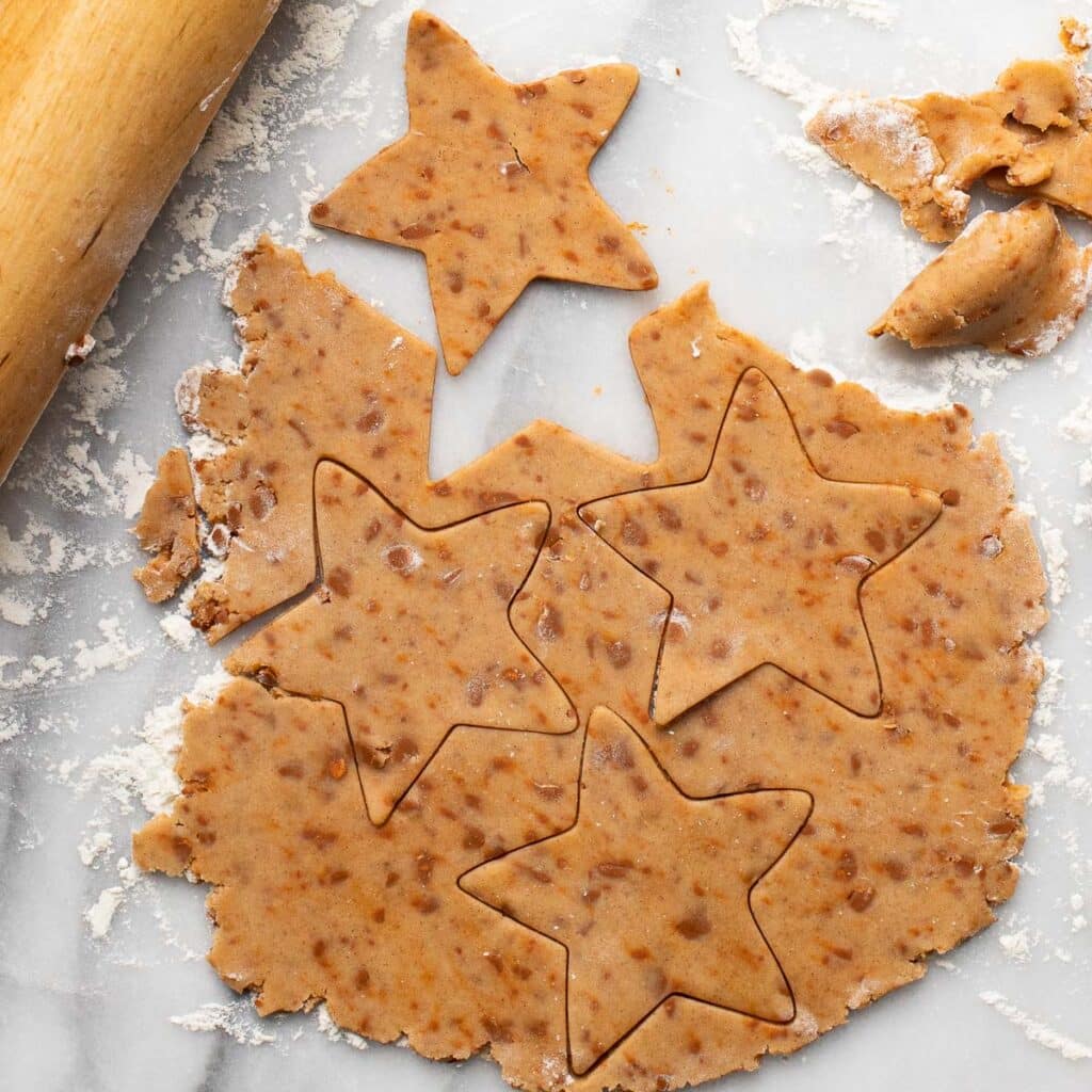 Cinnamon chip cookie dough, rolled out and cut into star shapes