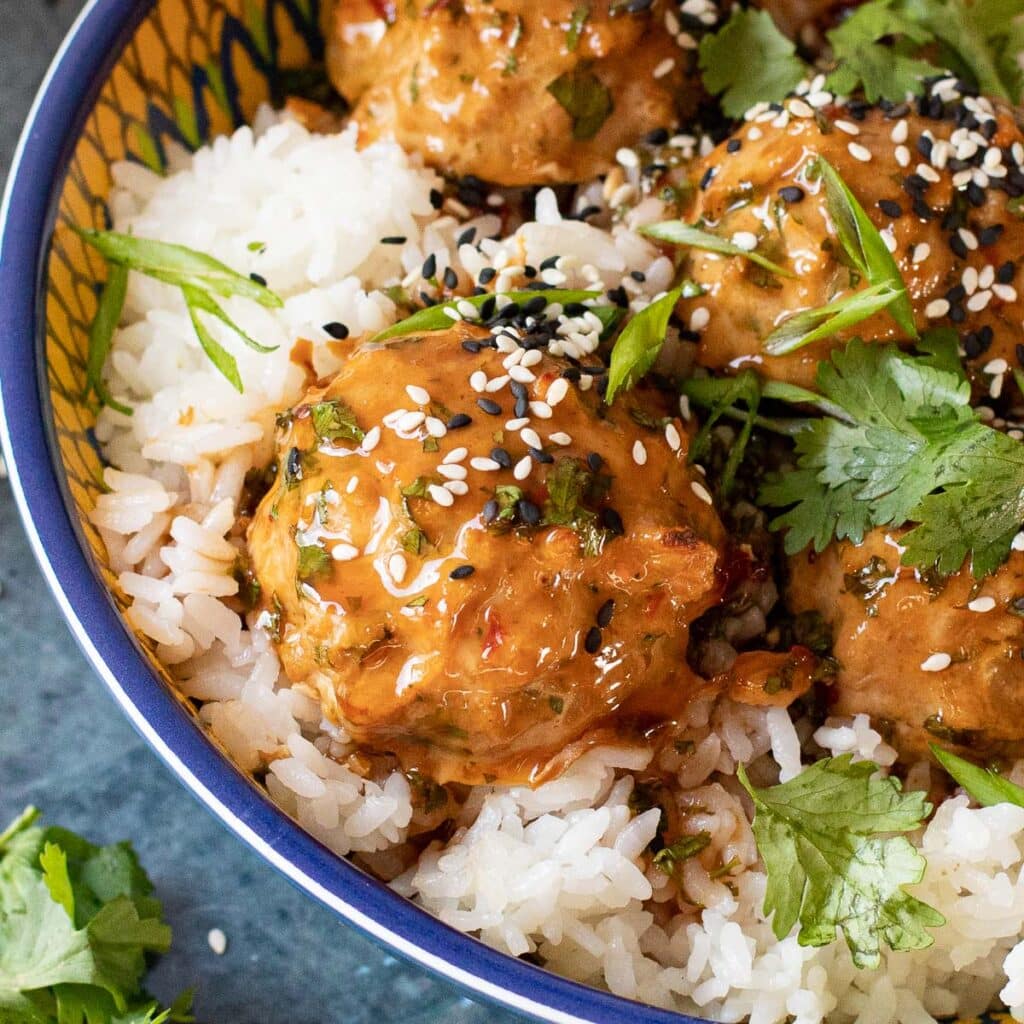 Chinese chicken meatball garnished with sesame seeds and cilantro