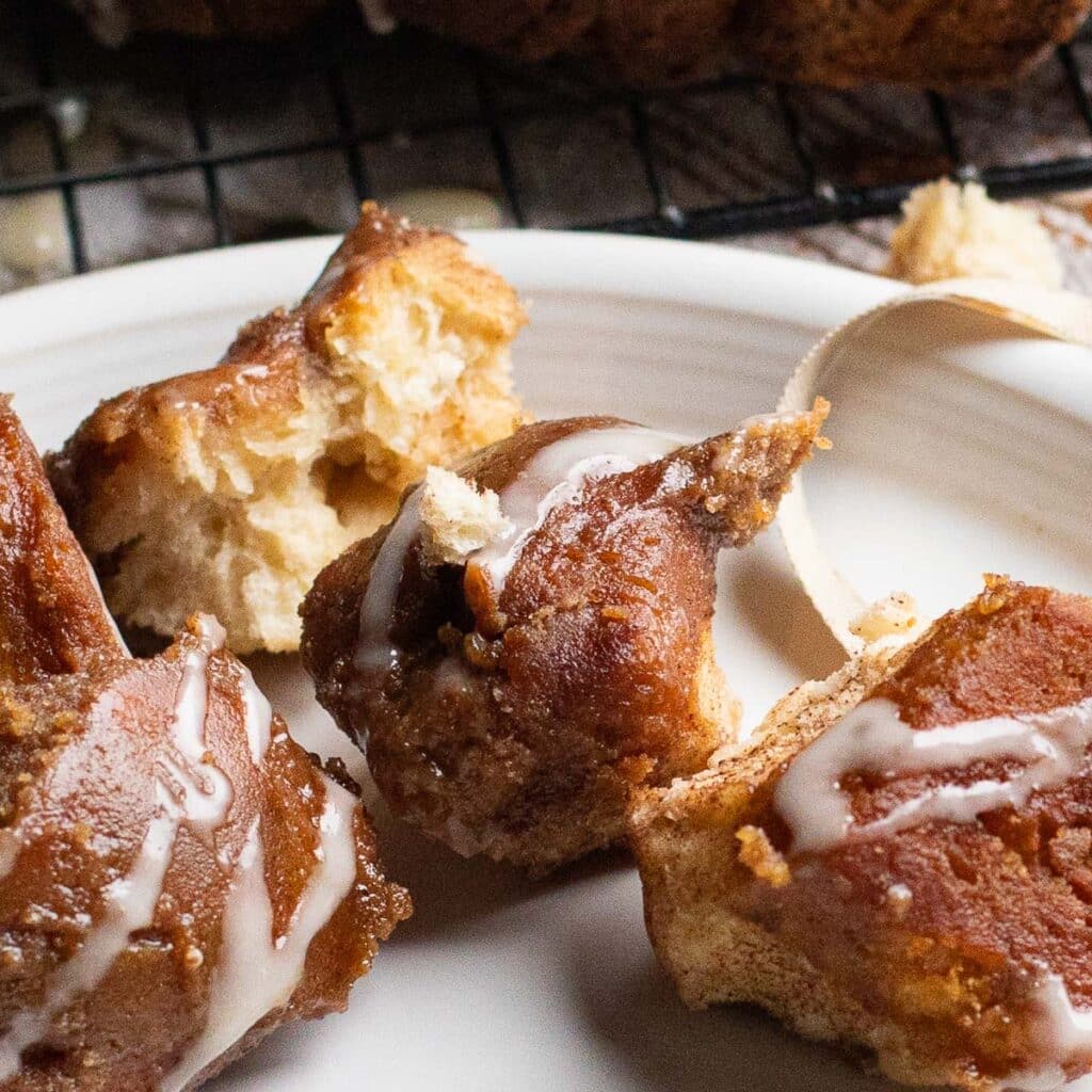 Close up of bite sized pieces of monkey bread with vanilla glaze