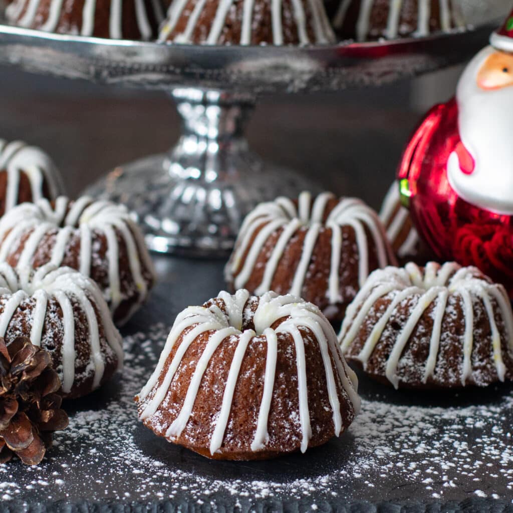 Individual gingerbread bundt cakes decorated with lemon frosting