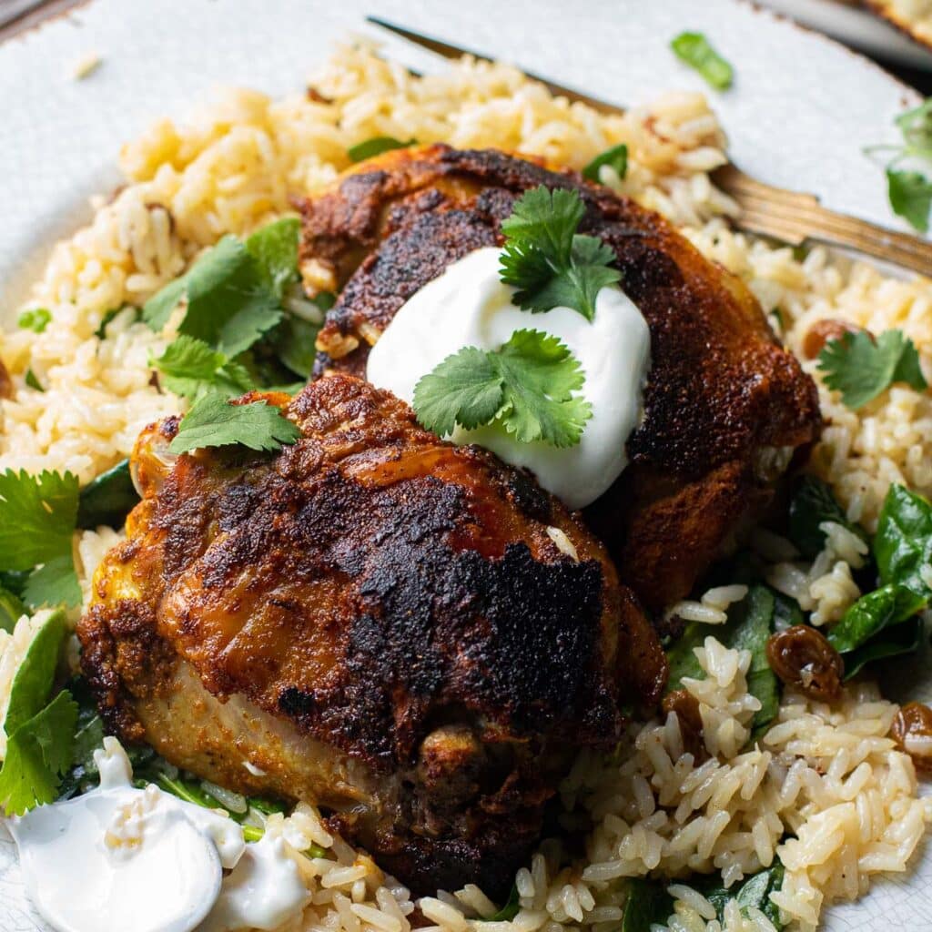 Indian Ginger Chicken topped with cream and cilantro