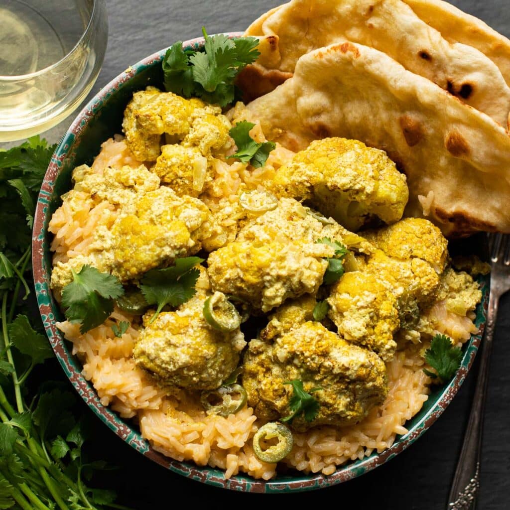 Curried Cauliflower on a bed of coconut rice with a side of naan bread