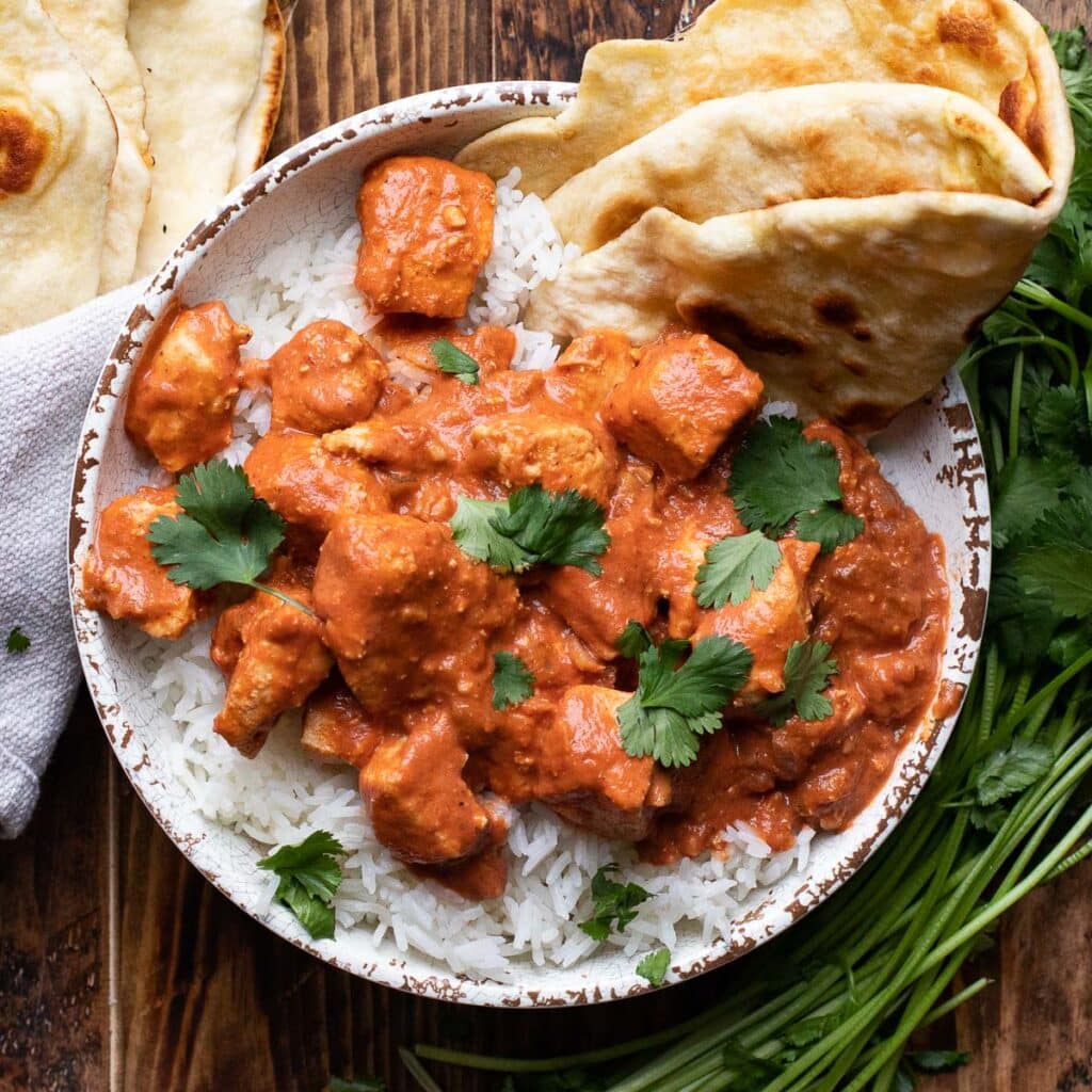 Ultimate Chicken Tikka Masala over white rice with naan bread