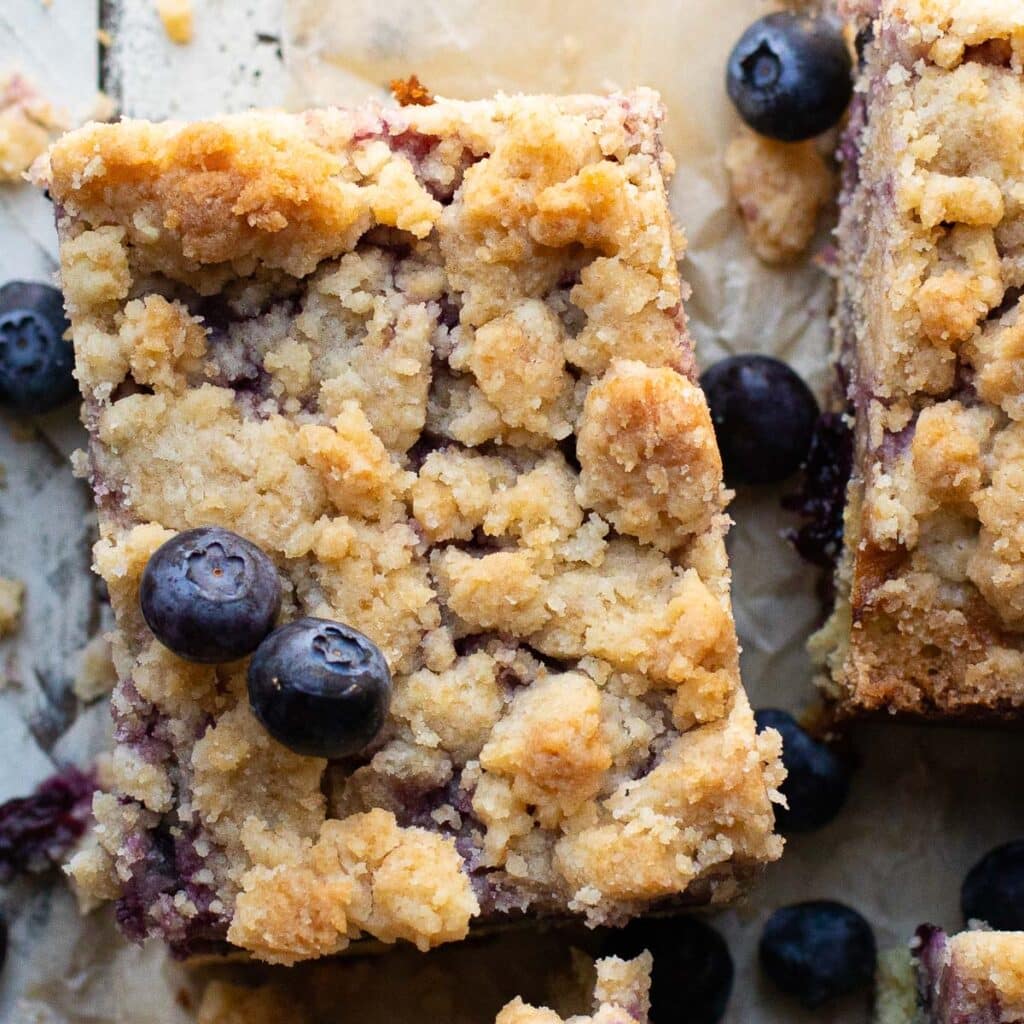 The top of a square piece of blueberry crumb cake