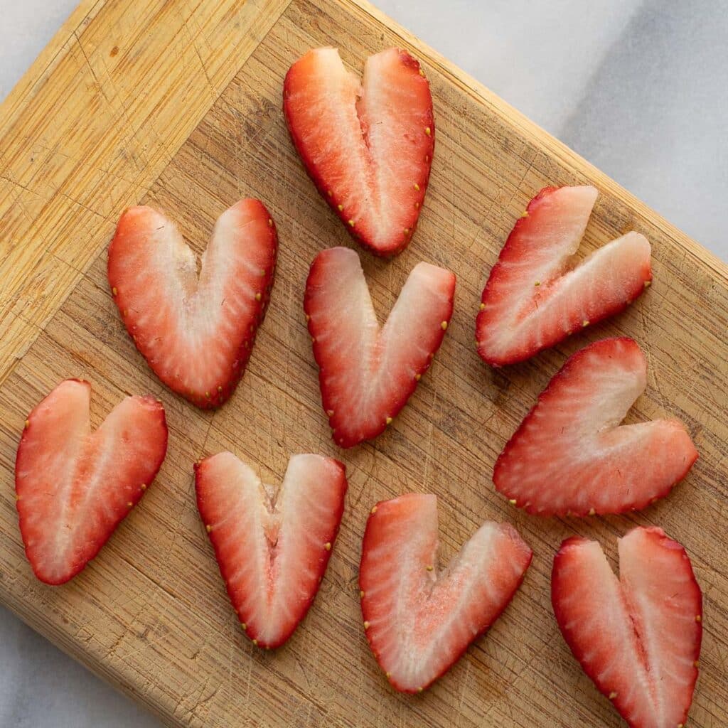 Slices of fresh strawberry in the shape of hearts