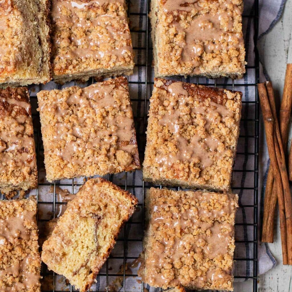 Square pieces of cinnamon swirl coffee cake on a wire rack