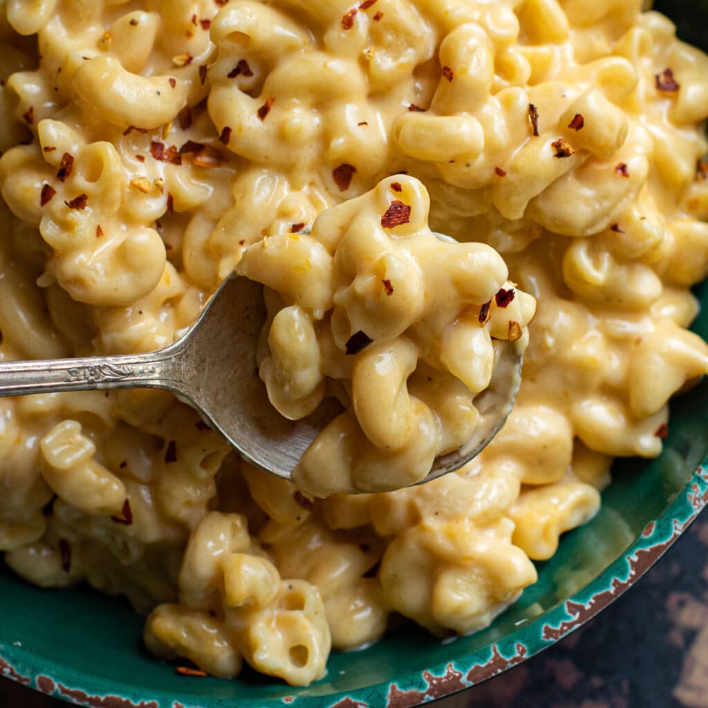 gluten free crock pot mac and cheese on a silver spoon