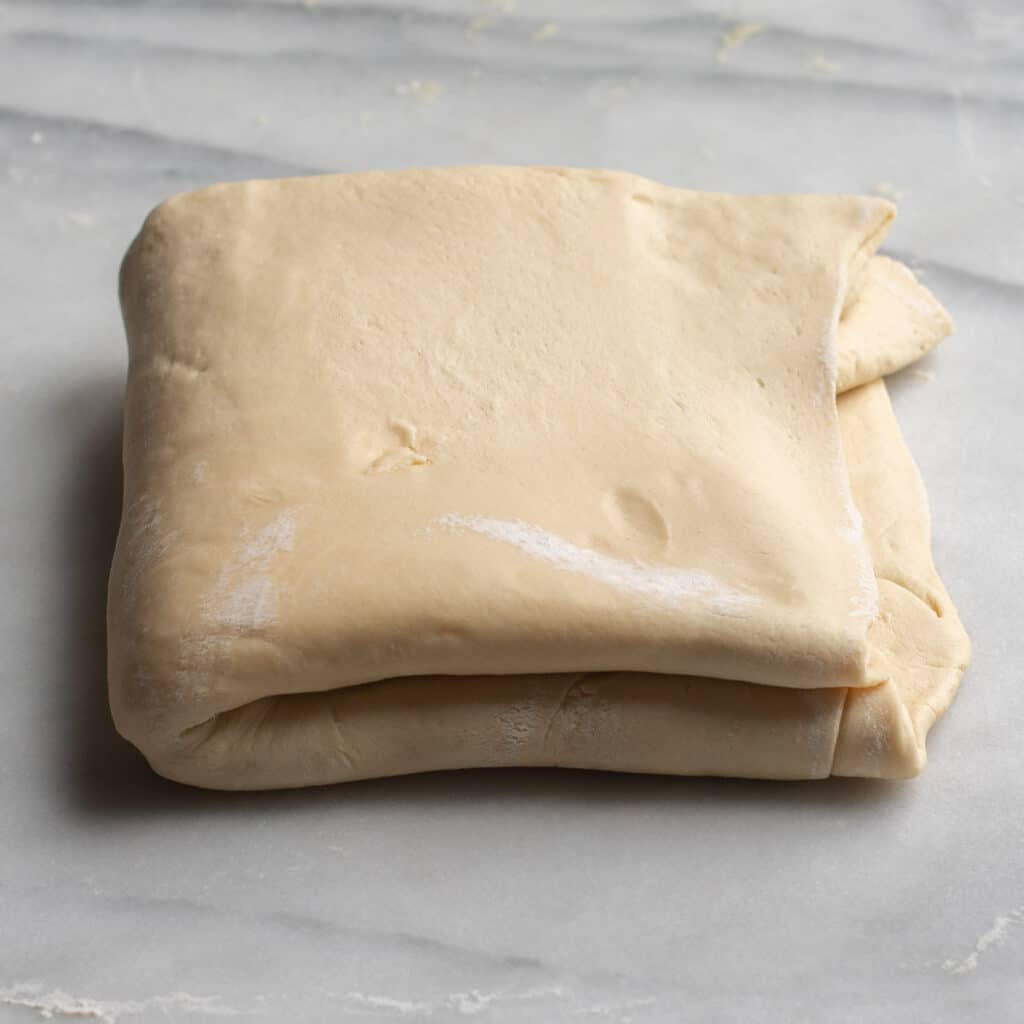 Laminated dough, folded on a marble board