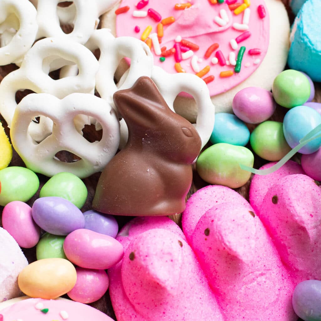 A chocolate bunny with miniature pretzels and pastel colored candies