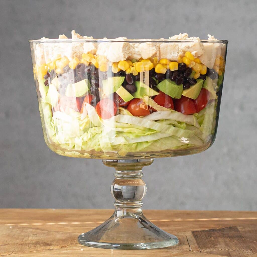southwestern layered salad in a trifle bowl