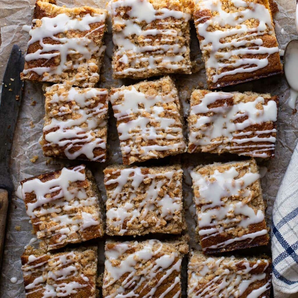 square pieces of cowboy coffee cake on a piece of parchment paper