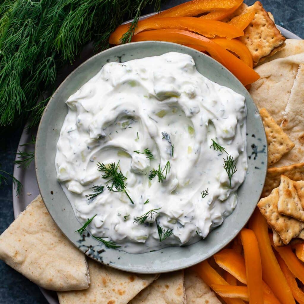 tzatziki dip in a bowl topped with fresh dill