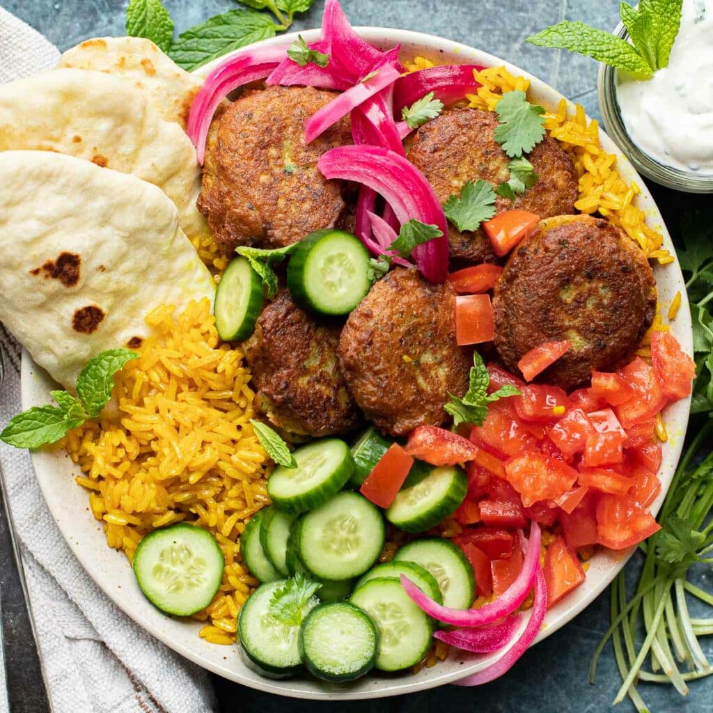 falafel over rice recipe with cucumbers, tomatoes and pickled onions