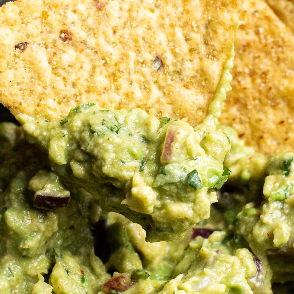a tortilla chip scooping up guacamole