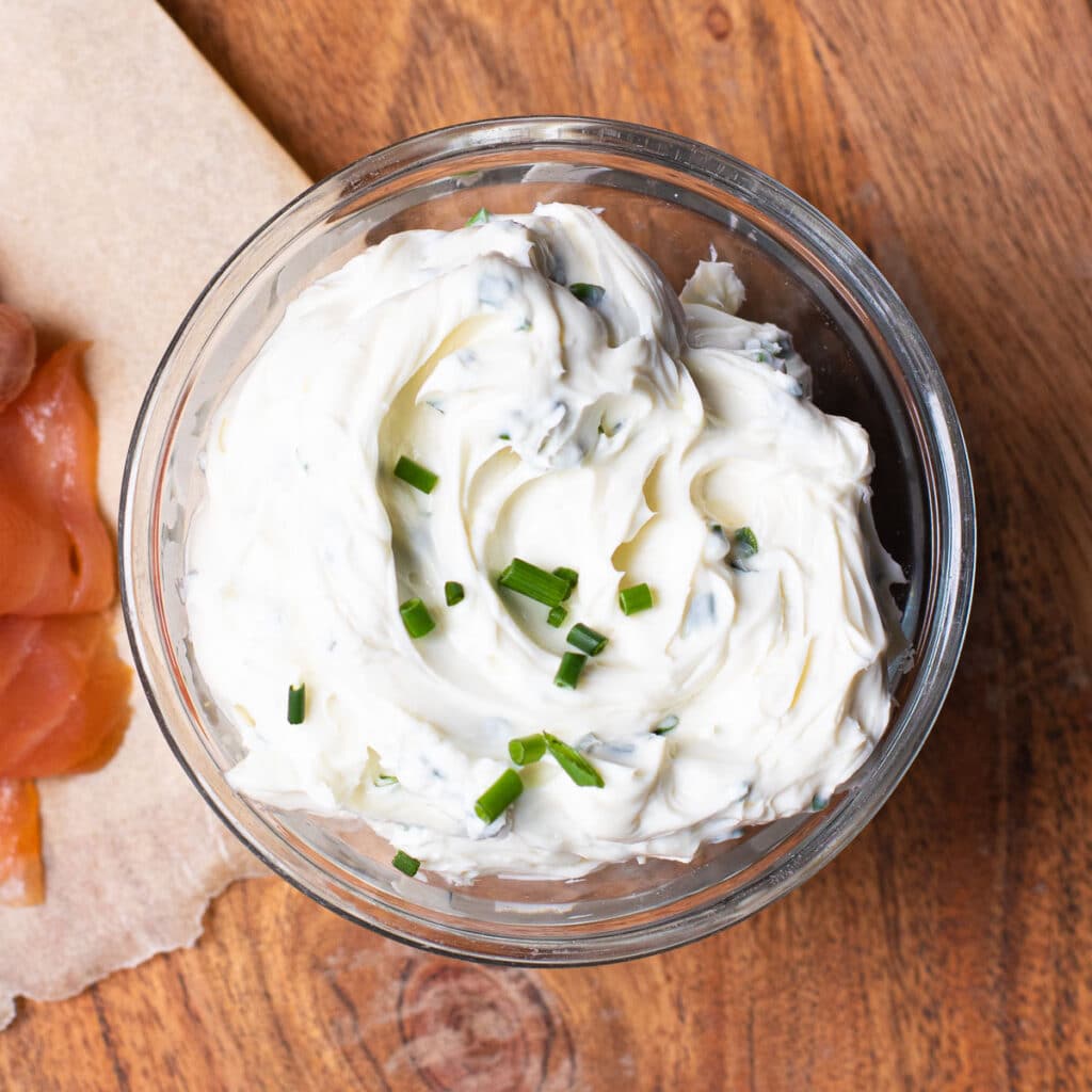 cream cheese in a glass bowl with chives