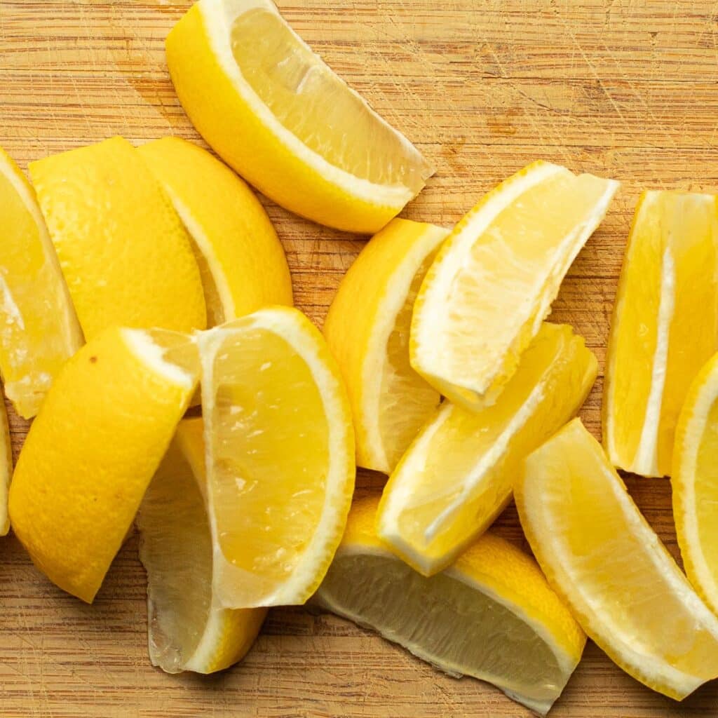 lemon wedges on a wooden cutting board