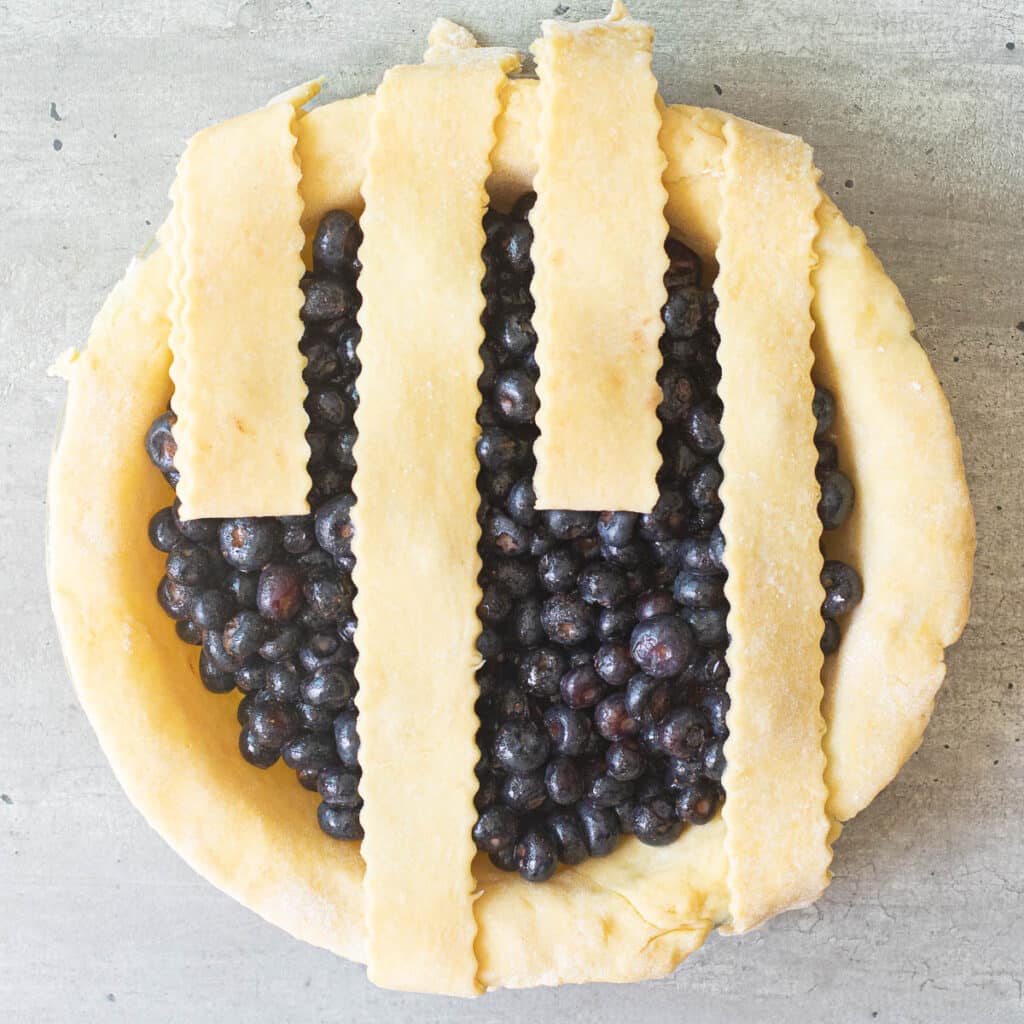 blueberry pie with every other lattice piece folded back