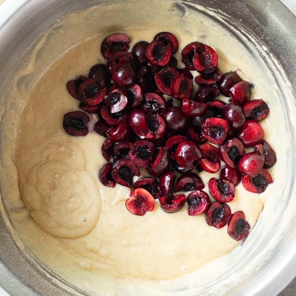 cherry bread batter and chopped cherries in a mixing bowl